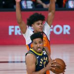 Indiana Pacers' Malcolm Brogdon (7) draws a foul from Phoenix Suns' Cameron Johnson during the second half of an NBA basketball game Thursday, Aug. 6, 2020, in Lake Buena Vista, Fla. (Kevin C. Cox/Pool Photo via AP)