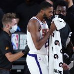 Phoenix Suns forward Mikal Bridges (25) gets medical attention during the second half of an NBA basketball game against the Philadelphia 76ers Tuesday, Aug. 11, 2020, in Lake Buena Vista, Fla. (AP Photo/Ashley Landis, Pool)
