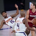 Phoenix Suns' Cameron Payne (15) falls to the court as Miami Heat's Kelly Olynyk (9) is charged with an offensive foul during the second half of an NBA basketball game, Saturday, Aug. 8, 2020 in Lake Buena Vista, Fla. (AP Photo/Ashley Landis, Pool)