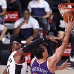 Los Angeles Clippers' Patrick Patterson, left, a shot from Phoenix Suns' Dario Saric during an NBA basketball game Tuesday, Aug. 4, 2020, in Lake Buena Vista, Fla. (Kevin C. Cox/Pool Photo via AP)