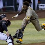 San Diego Padres' Jorge Mateo tries to score as Arizona Diamondbacks catcher Carson Kelly waits for the throw during the ninth inning of a baseball game Saturday, Aug. 15, 2020, in Phoenix. Mateo was out on the play for the final out of the game. The Diamondbacks won 7-6. (AP Photo/Matt York)