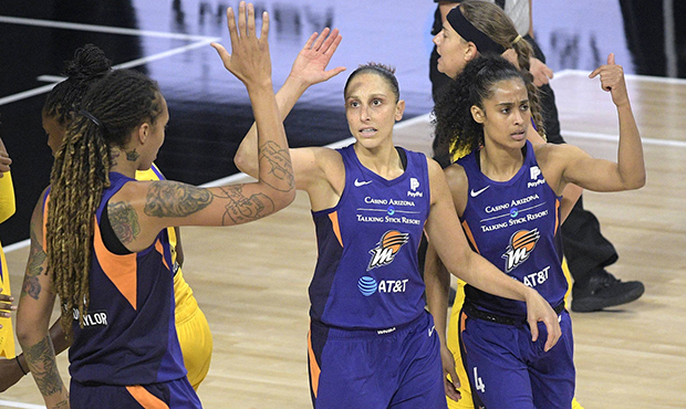Phoenix Mercury guard Diana Taurasi (3) is congratulated by center Brittney Griner, left, and Skyla...