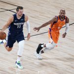 Dallas Mavericks' Luka Doncic (77) brings the ball down the court as Phoenix Suns' Jevon Carter defends during the first half of an NBA basketball game Thursday, Aug. 13, 2020 in Lake Buena Vista, Fla. (AP Photo/Ashley Landis, Pool)