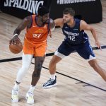 Phoenix Suns' Deandre Ayton, left, dribbles as Dallas Mavericks' Maxi Kleber (42) defends during the first half of an NBA basketball game Thursday, Aug. 13, 2020 in Lake Buena Vista, Fla. (AP Photo/Ashley Landis, Pool)