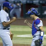 Los Angeles Dodgers relief pitcher Kenley Jansen, left, and Dodgers catcher Austin Barnes, right, celebrate after the final out in ninth inning of a baseball game against the Arizona Diamondbacks Sunday, Aug. 2, 2020, in Phoenix. The Dodgers defeated the Diamondbacks 3-0. (AP Photo/Ross D. Franklin)
