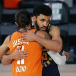 Indiana Pacers' Naz Mitrou-Long, rear, and Phoenix Suns' Ricky Rubio (11) hug at the end of an NBA basketball game Thursday, Aug. 6, 2020, in Lake Buena Vista, Fla. (Kevin C. Cox/Pool Photo via AP)