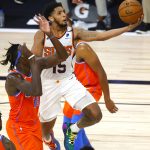 Phoenix Suns' Cameron Payne, top, goes up to shoot against Oklahoma City Thunder's Kevin Hervey, left, during the fourth quarter of an NBA basketball game Monday, Aug. 10, 2020, in Lake Buena Vista, Fla. (Mike Ehrmann/Pool Photo via AP)
