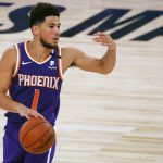 Phoenix Suns' Devin Booker directs his teammates during an NBA basketball game against the Los Angeles Clippers' Tuesday, Aug. 4, 2020, in Lake Buena Vista, Fla. (Kevin C. Cox/Pool Photo via AP)