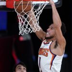 Phoenix Suns' Devin Booker (1) dunks during the first half of an NBA basketball game against the Miami Heat, Saturday, Aug. 8, 2020 in Lake Buena Vista, Fla. (AP Photo/Ashley Landis, Pool)