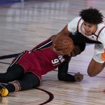 Phoenix Suns' Cameron Johnson, right, falls to the court as Miami Heat's Jae Crowder defends during the first half of an NBA basketball game, Saturday, Aug. 8, 2020 in Lake Buena Vista, Fla. (AP Photo/Ashley Landis, Pool)