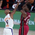 Phoenix Suns' Jevon Carter (4) defends Miami Heat's Bam Adebayo (13) during the second half of an NBA basketball game, Saturday, Aug. 8, 2020, in Lake Buena Vista, Fla. (AP Photo/Ashley Landis, Pool)