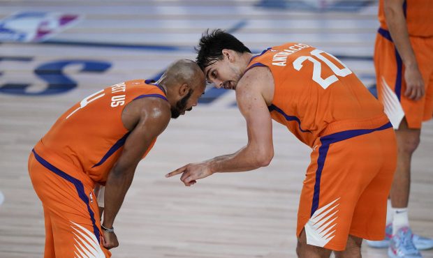 Phoenix Suns guard Jevon Carter (4) and forward Dario Saric (20) talk during a break in play during...