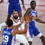 Philadelphia 76ers guard Raul Neto (19) looks to pass to teammate guard Shake Milton, right, as Phoenix Suns guard Ricky Rubio (11) defends during the second half of an NBA basketball game Tuesday, Aug. 11, 2020, in Lake Buena Vista, Fla. (AP Photo/Ashley Landis, Pool)