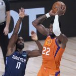 Phoenix Suns' Deandre Ayton (22) passes over Dallas Mavericks' Tim Hardaway Jr. (11) during the first half of an NBA basketball game Thursday, Aug. 13, 2020 in Lake Buena Vista, Fla. (AP Photo/Ashley Landis, Pool)