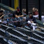 Arizona Diamondbacks players watch from the stands during the first inning of a baseball game against the San Diego Padres Saturday, Aug. 15, 2020, in Phoenix. (AP Photo/Matt York)