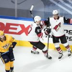 Nashville Predators' Filip Forsberg (9) skates past as Arizona Coyotes' Lawson Crouse (67) and Michael Grabner (40) celebrate a goal during second-period NHL hockey Stanley Cup qualifying round game action in Edmonton, Alberta, Sunday, Aug. 2, 2020. (Jason Franson/The Canadian Press via AP)