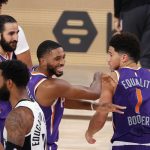 Phoenix Suns' Devin Booker (1) celebrates with teammate Mikal Bridges after scoring the game winning basket against the Los Angeles Clippers in an NBA basketball game Tuesday, Aug. 4, 2020, in Lake Buena Vista, Fla. (Kevin C. Cox/Pool Photo via AP)