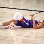 Phoenix Suns' Devin Booker reacts after running into a screen against the Los Angeles Clippers during an NBA basketball game Tuesday, Aug. 4, 2020, in Lake Buena Vista, Fla. (Kevin C. Cox/Pool Photo via AP)