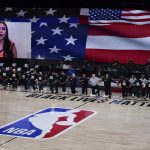 Phoenix Suns and Dallas Mavericks players kneel during the singing of the national anthem before playing in an NBA basketball game Sunday, Aug. 2, 2020, in Lake Buena Vista, Fla. (AP Photo/Ashley Landis, Pool)