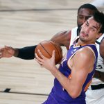 Los Angeles Clippers' Patrick Patterson, rear, defends Phoenix Suns' Dario Saric during an NBA basketball game Tuesday, Aug. 4, 2020, in Lake Buena Vista, Fla. (Kevin C. Cox/Pool Photo via AP)