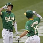 
              Oakland Athletics' Matt Chapman, right, celebrates with Mark Canha after hitting a home run off Arizona Diamondbacks pitcher Alex Young in the first inning of a baseball game Thursday, Aug. 20, 2020, in Oakland, Calif. (AP Photo/Ben Margot)
            