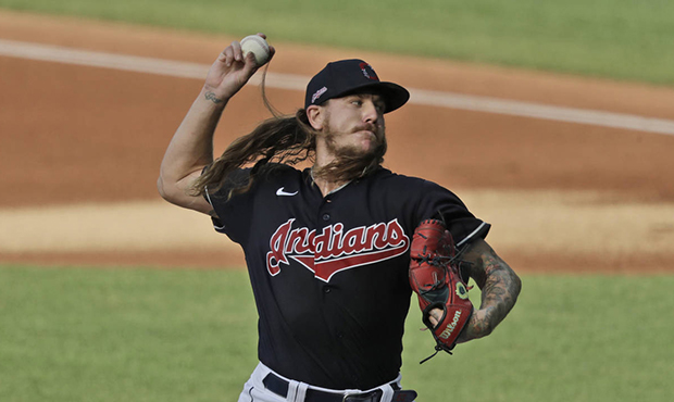 Cleveland Indians starting pitcher Mike Clevinger delivers in the first inning during a preseason b...