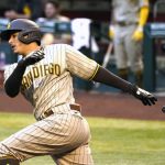 
              San Diego Padres' Manny Machado hits in the first inning during a baseball game against the Arizona Diamondbacks, Friday, Aug 14, 2020, in Phoenix. (AP Photo/Rick Scuteri)
            