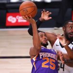Patrick Patterson, right, of the Los Angeles Clippers, defends a shot from Mikal Bridges, left, of the Phoenix Suns  during an NBA basketball game Tuesday, Aug. 4, 2020, in Lake Buena Vista, Fla. (Kevin C. Cox/Pool Photo via AP)