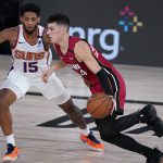 Miami Heat's Tyler Herro (14) is defended by Phoenix Suns' Cameron Payne (15) during the second half of an NBA basketball game, Saturday, Aug. 8, 2020 in Lake Buena Vista, Fla. (AP Photo/Ashley Landis, Pool)