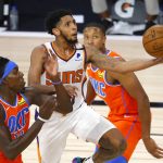 Phoenix Suns' Cameron Payne, center, goes up to shoot against Oklahoma City Thunder's Kevin Hervey, left, during the fourth quarter of an NBA basketball game Monday, Aug. 10, 2020, in Lake Buena Vista, Fla. (Mike Ehrmann/Pool Photo via AP)