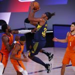 Indiana Pacers' Myles Turner (33) shoots during the second quarter as Phoenix Suns' Deandre Ayton (22) and Devin Booker (1) defend during an NBA basketball game Thursday, Aug. 6, 2020, in Lake Buena Vista, Fla. (Kevin C. Cox/Pool Photo via AP)