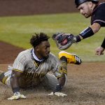 San Diego Padres' Jorge Mateo is tagged out by Arizona Diamondbacks catcher Carson Kelly for the final out of the game during the ninth inning of a baseball game Saturday, Aug. 15, 2020, in Phoenix.The Diamondbacks won 7-6. (AP Photo/Matt York)