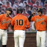 San Francisco Giants' Evan Longoria (10) is congratulated by teammates Hunter Pence (8) and Wilmer Flores (41) after hitting a two-run home run against the Arizona Diamondbacks during the third inning of a baseball game in San Francisco, Friday, Aug. 21, 2020. (AP Photo/Tony Avelar)
