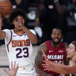Phoenix Suns' Cameron Johnson (23) looks to pass as Miami Heat's Kelly Olynyk, right, defends during the second half of an NBA basketball game, Saturday, Aug. 8, 2020, in Lake Buena Vista, Fla. (AP Photo/Ashley Landis, Pool)