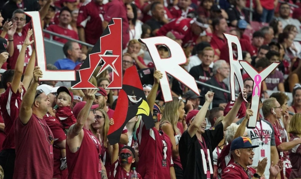 Arizona Cardinals fans cheer on Larry Fitzgerald during the second half of an NFL football game aga...