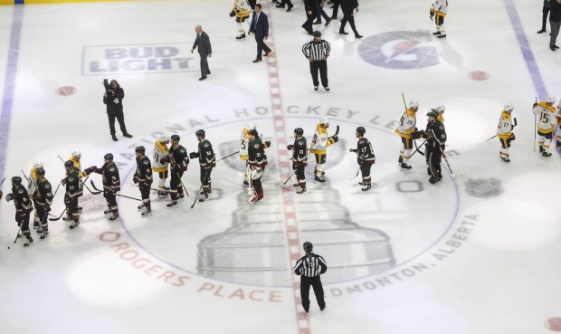 Nashville Predators and the Arizona Coyotes shake hands following overtime in an NHL hockey playoff...