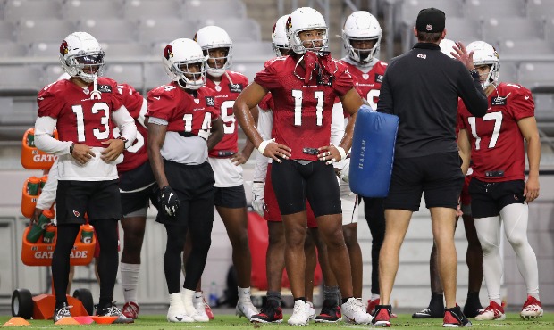 Wide receiver Larry Fitzgerald #11 (C) of the Arizona Cardinals stands with teammates Christian Kir...