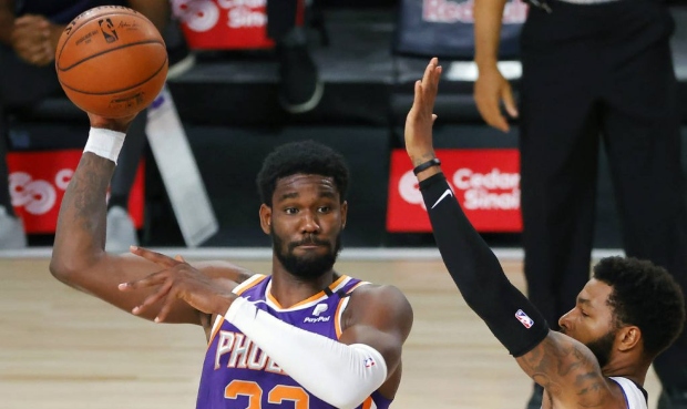 Los Angeles Clippers' Marcus Morris Sr., right, defends Phoenix Suns' Deandre Ayton (22) during an ...
