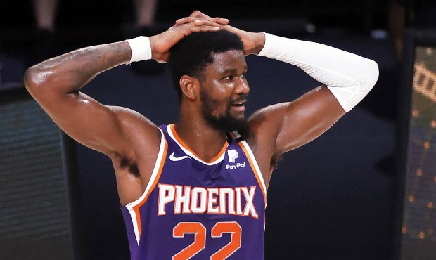Phoenix Suns' Deandre Ayton  reacts after being charged with a foul during an NBA basketball game a...