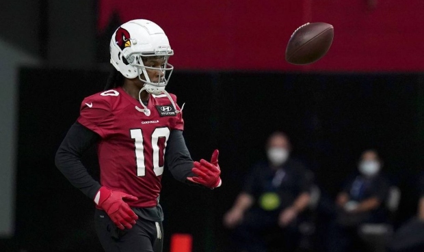 Arizona Cardinals' DeAndre Hopkins flips the football away after making a catch as wide receivers r...