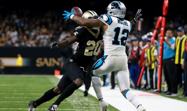Ken Crawley #20 of the New Orleans Saints breaks up a pass intended for D.J. Moore #12 of the Carol...