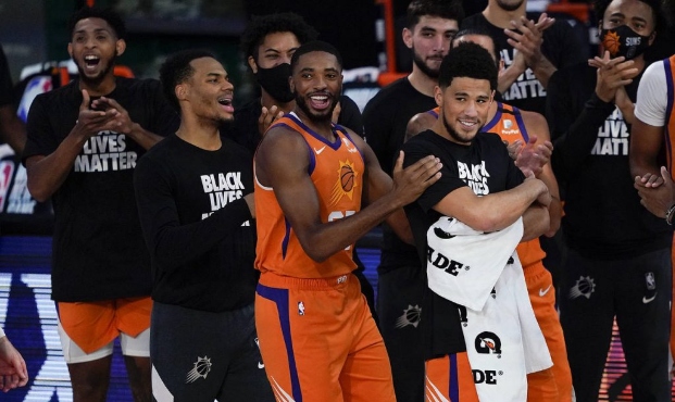 Phoenix Suns players react during player introductions before playing against the Dallas Mavericks ...