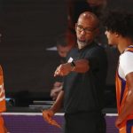 Phoenix Suns head coach Monty Williams talks with forwards Cameron Johnson (23) and Mikal Bridges (25) during the second half of an NBA basketball game against the Washington Wizards, Friday, July 31, 2020, in Lake Buena Vista, Fla. (Kim Klement/Pool Photo via AP)