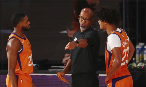 Phoenix Suns head coach Monty Williams talks with forwards Cameron Johnson (23) and Mikal Bridges (...