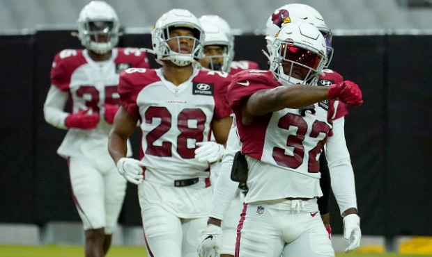 Arizona Cardinals safety Budda Baker (32) leads teammates onto the field during an NFL football tra...