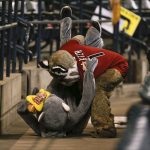 Arizona Diamondbacks mascot D. Baxter, top, throws an imposter mascot Rat Leon to the floor after Rat Leon infiltrated the stands during their baseball game against the Colorado Rockies, Sunday, Sept. 27, 2020, in Phoenix. (AP Photo/Darryl Webb)
