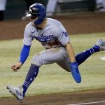 Los Angeles Dodgers' Enrique Hernandez tries to steal home during the sixth inning of a baseball game against the Arizona Diamondbacks, Thursday, Sept. 10, 2020, in Phoenix. Hernandez was tagged out on the play. (AP Photo/Matt York)