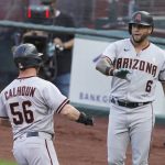 Arizona Diamondbacks' Kole Calhoun (56) is greeted by David Peralta after scoring during the first inning of the team's baseball game against the San Francisco Giants on Saturday, Sept. 5, 2020, in San Francisco. Calhoun scored on a sacrifice fly by Christian Walker. (AP Photo/Eric Risberg)