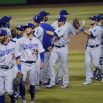 The Los Angeles Dodgers celebrate after a baseball game against the Arizona Diamondbacks, Tuesday, Sept. 8, 2020, in Phoenix. The Dodgers won 10-9 in 10 innings. (AP Photo/Matt York)