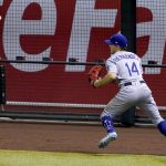 Los Angeles Dodgers' Enrique Hernandez plays an RBI triple off the fence hit by Arizona Diamondbacks' Daulton Varsho during the sixth inning of a baseball game, Thursday, Sept. 10, 2020, in Phoenix. (AP Photo/Matt York)